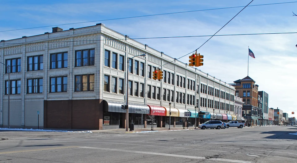 Multi-story commercial building with storefronts along a downtown street
